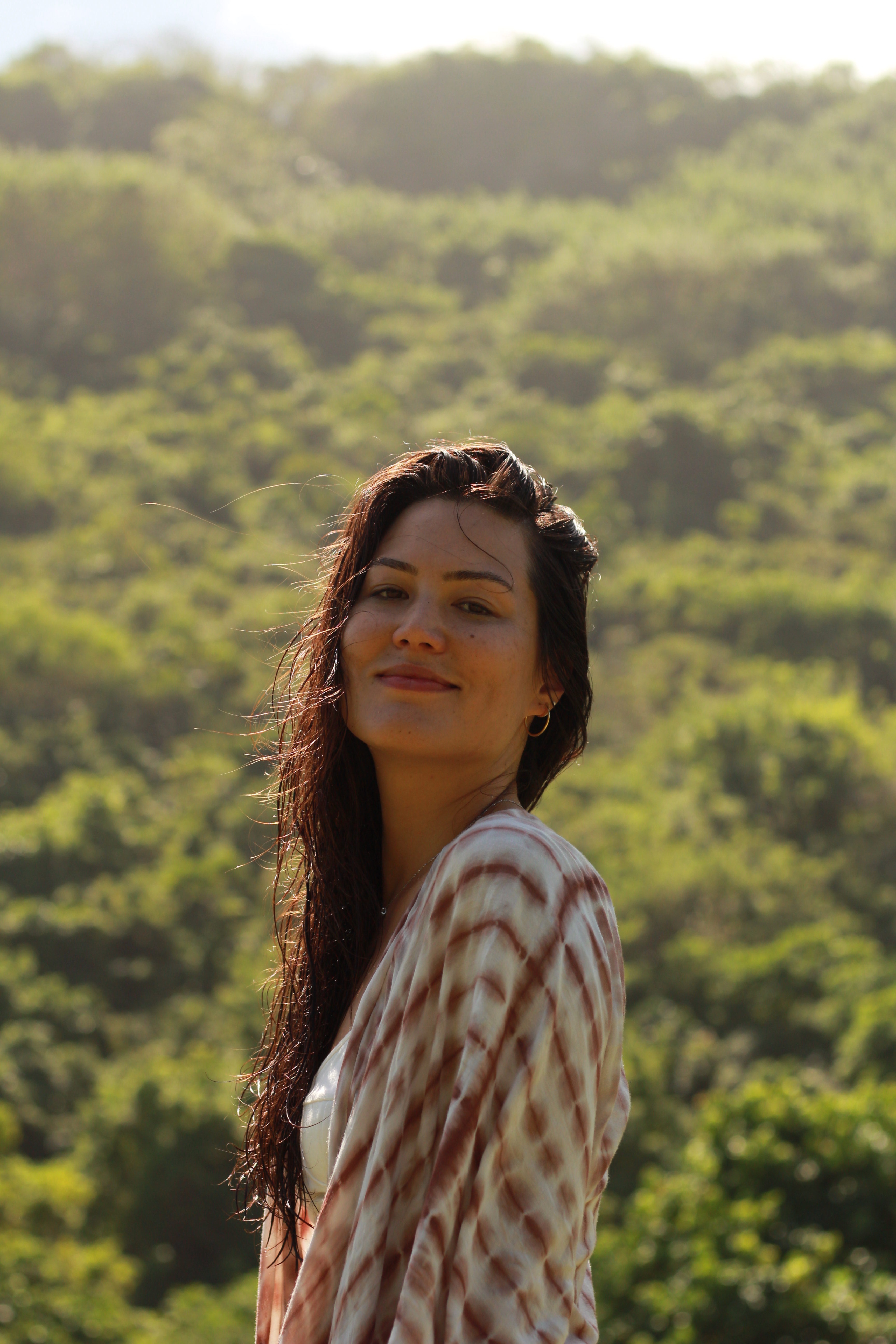 Portrait of Karin Rechsteiner smiling outdoors in front of a green hillside